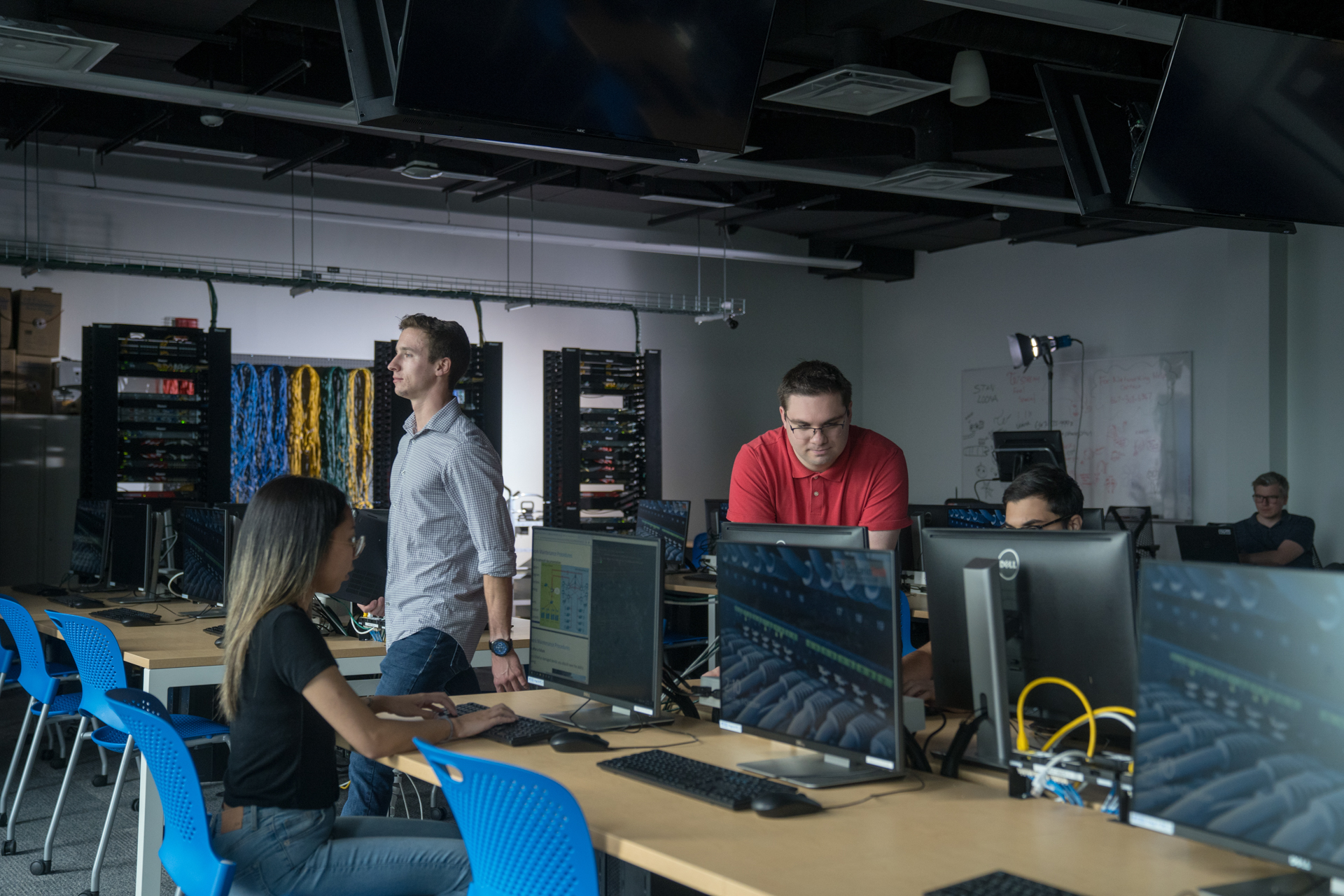 Students are collaborating and studying in a computer lab.