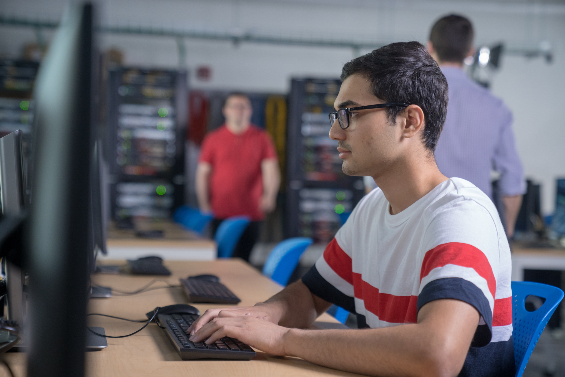 Student sitting on computer in a lab.
