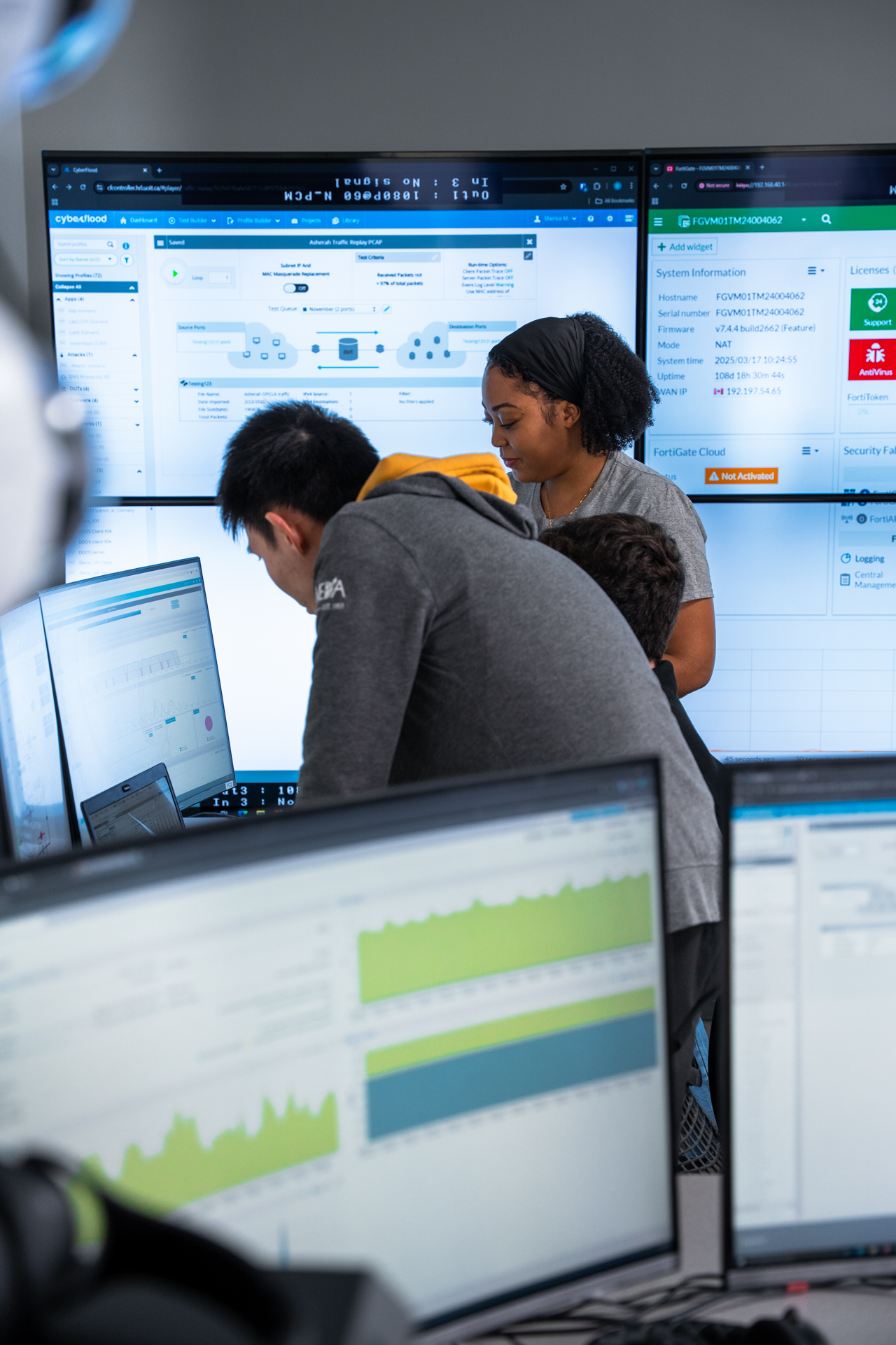 Two students looking at computer screens with computer screens in the background