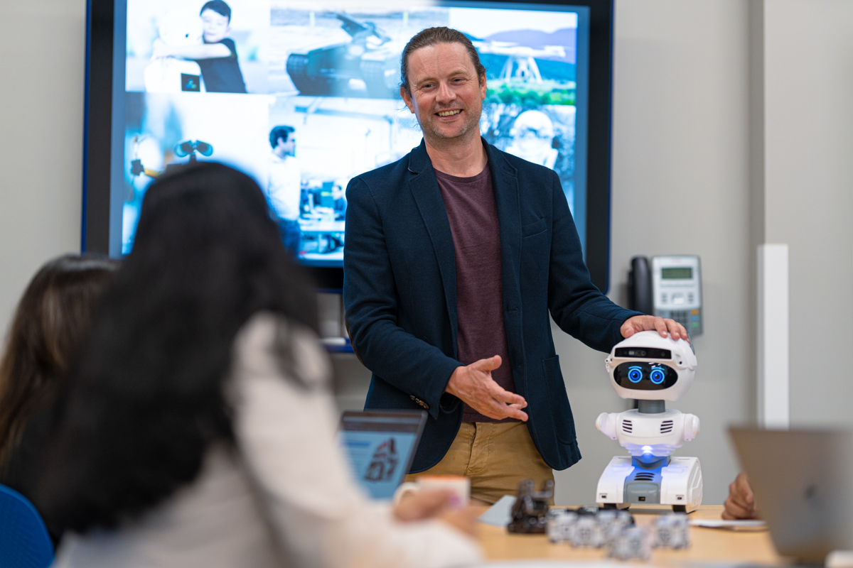 Peter Lewis with AI robot