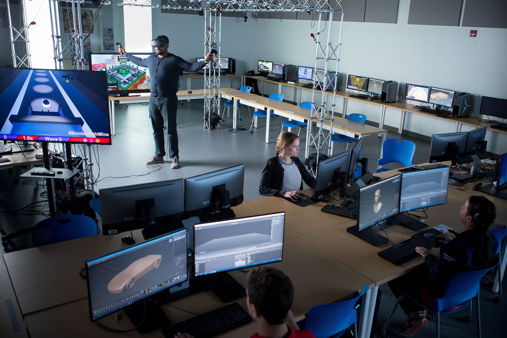A group of students are working in a computer lab designing software.