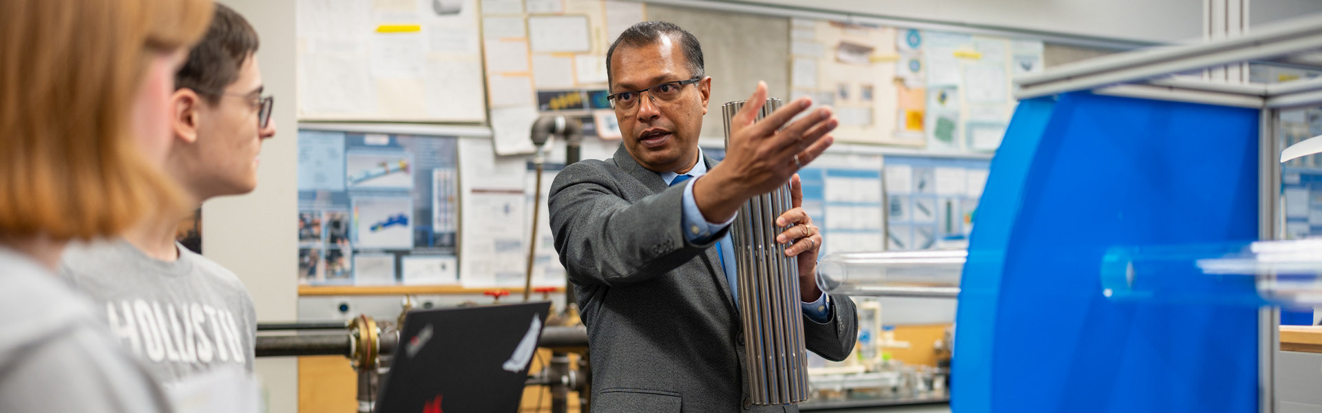 Researcher demonstrating to students in a lab