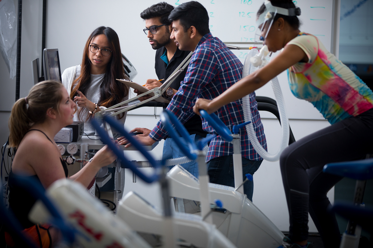 Students on exercise bikes.