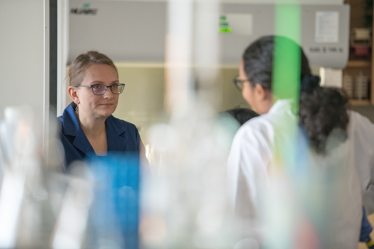 A professor and a student in a lab speaking