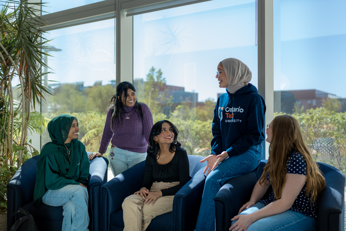 life on campus image showing talking, students, smiling, north campus, common area, sitting, glass, ace at automotive centre of excellence