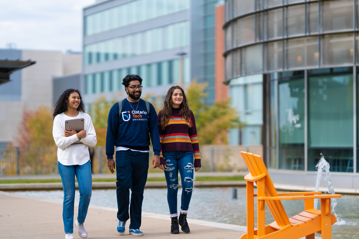 life on campus image showing common area, glass, lawn chairs, lib, library, north campus, outdoors, smiling, students at polonsky commons