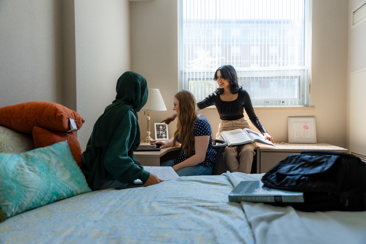 life on campus image showing north campus, smiling, students, residence, bed at residence