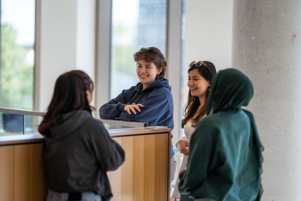 A group of students are talking and laughing together.