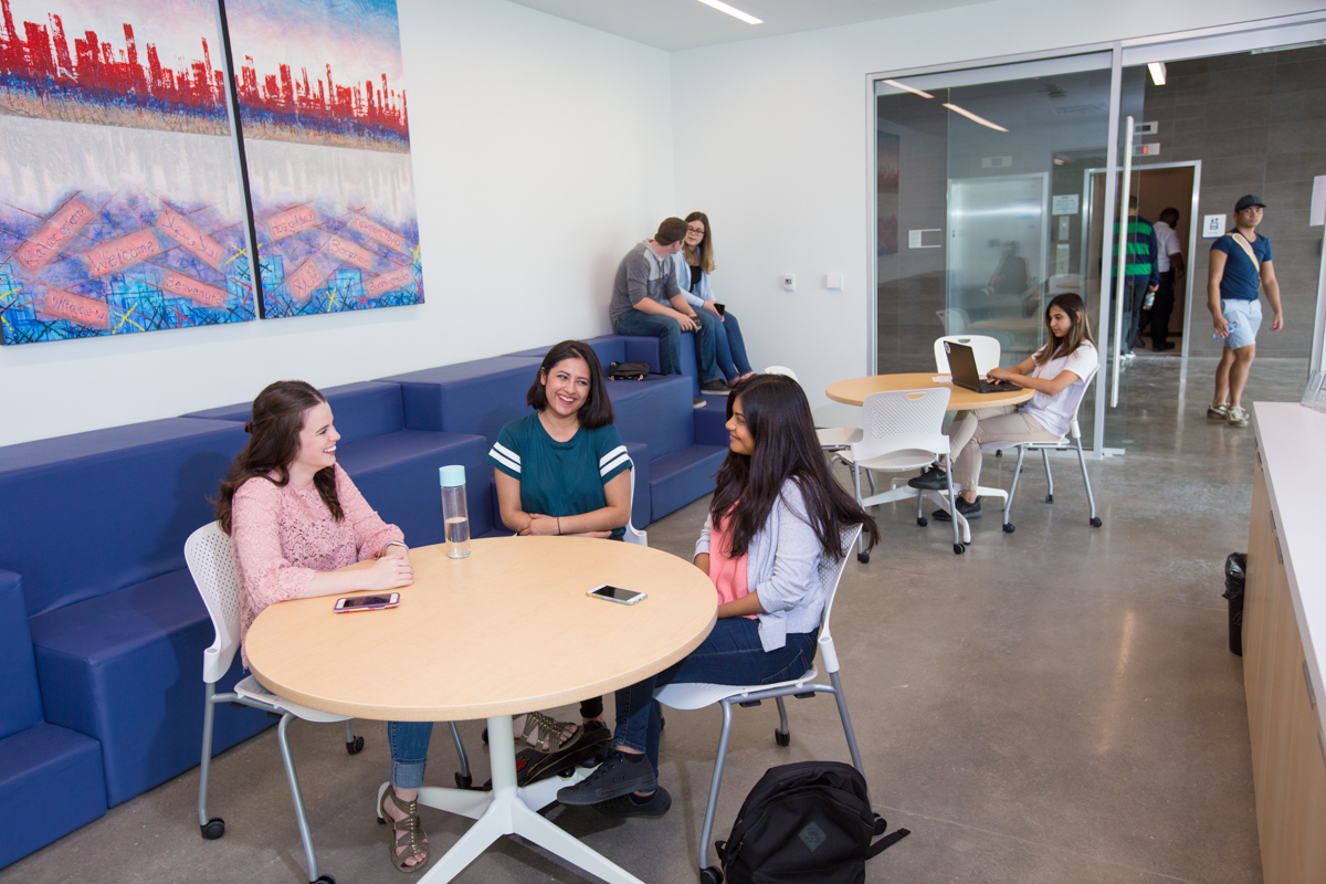 life on campus image showing chairs, common area, computer, glass, north campus, sitting, smiling, students, tables, talking at software and informatics research centre