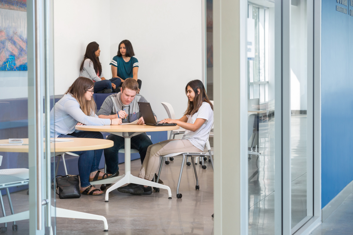 Students sitting at a table in a common area