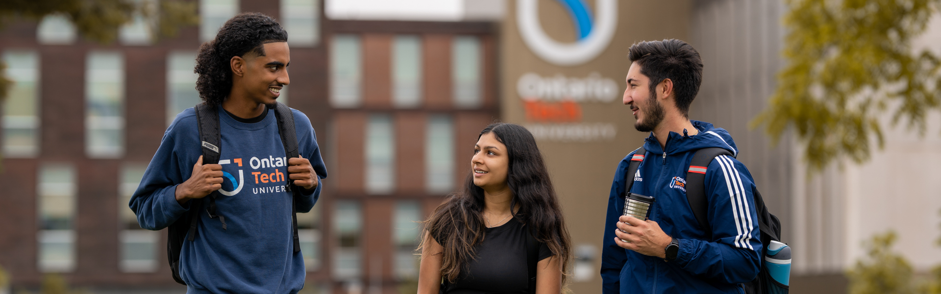 students standing outside on campus. 