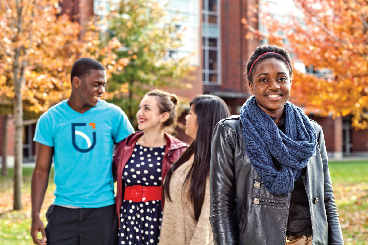 life on campus image showing brick, common area, logo, north campus, ontario tech, outdoors, polonsky, smiling, students, trees at polonsky commons