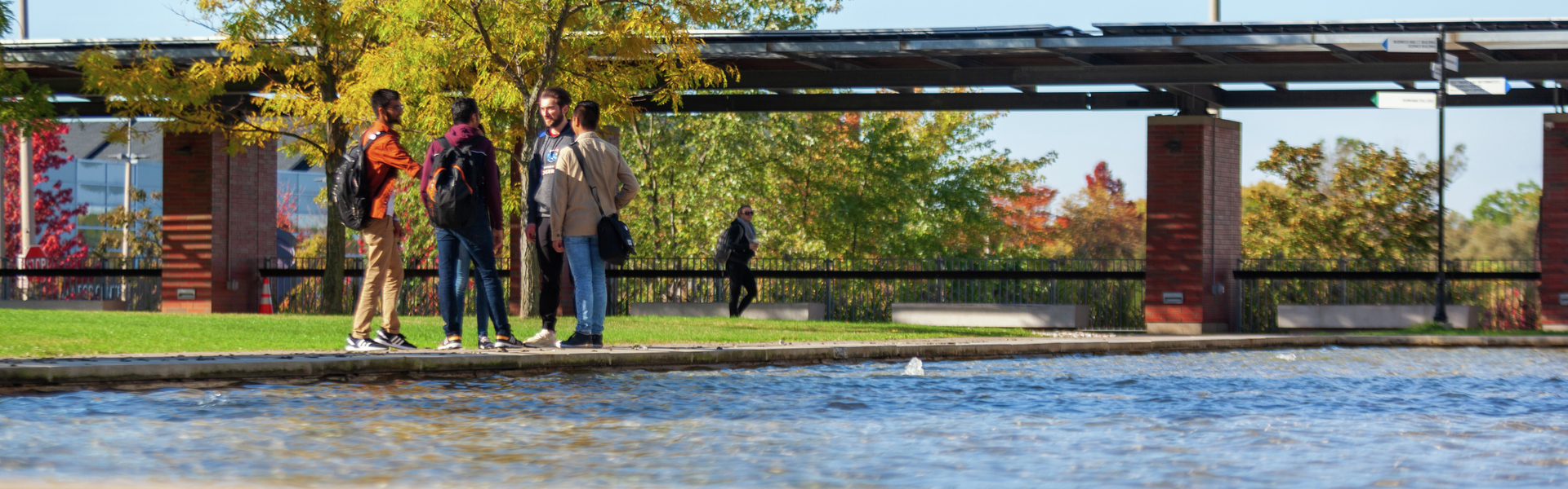 life on campus image showing students, discussion, outdoors, polonsky at polonsky commons