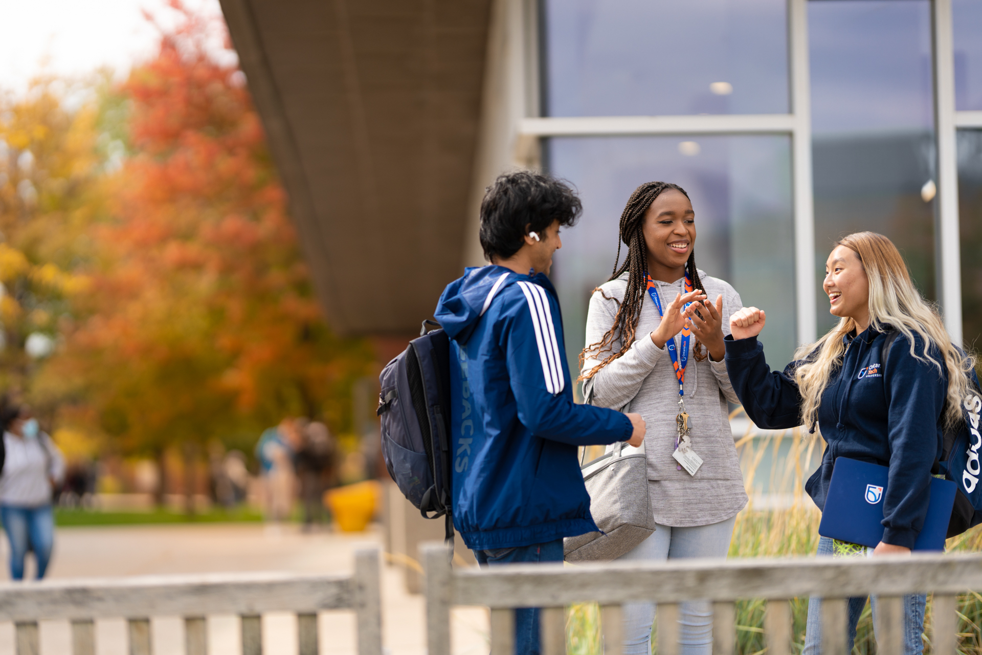 life on campus image showing common area, glass, north campus, outdoors, smiling, students at polonsky commons